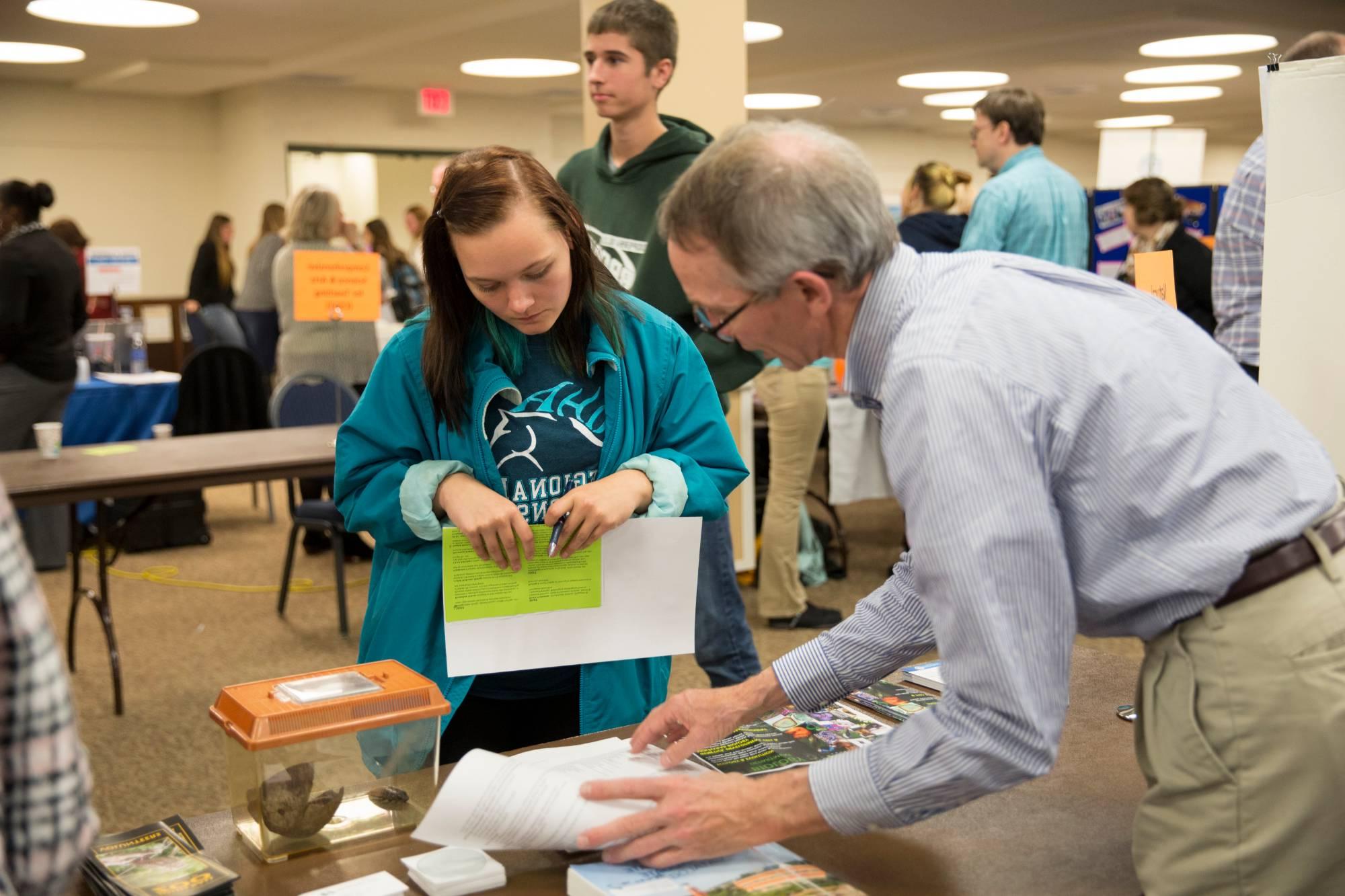 Professor helping student understand the elements of a major they are curious about.